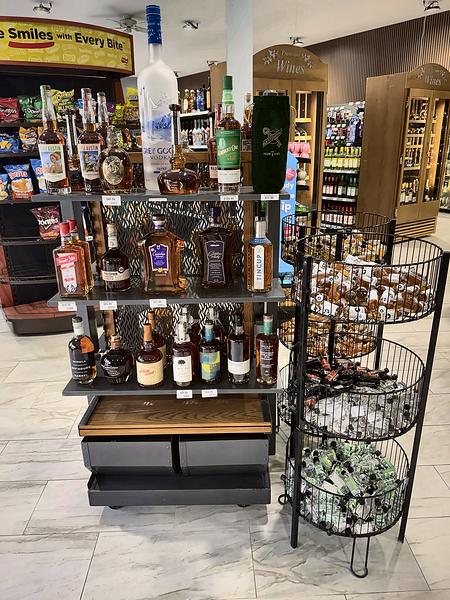 Featured bottles and baskets of minis, with wooden wine cabinets in the background