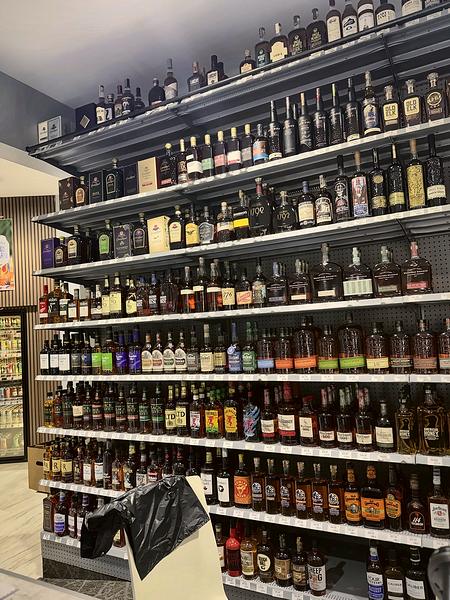 Floor-to-ceiling wall of whiskey and bourbon behind the counter
