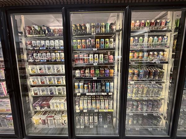 Cooler of cold cans and single tallboys, stocked door to door