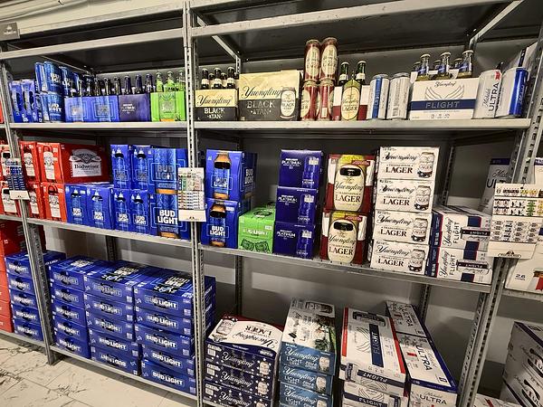 Domestic beer cases and packs stacked on the shelves